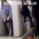 A hidden camera video features two women peeing into the toilets of a public restroom without doors on the stalls. No audio.